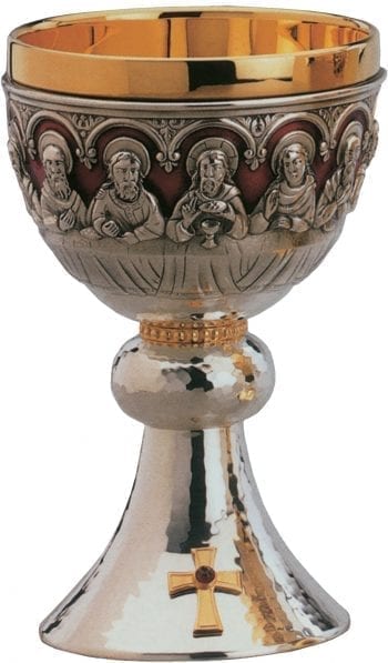 Romanesque chalice Last Supper with embossed figures of the Apostles and Jesus and embellished with a cross with ruby red stone